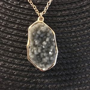 Gold chain with grey jagged stone